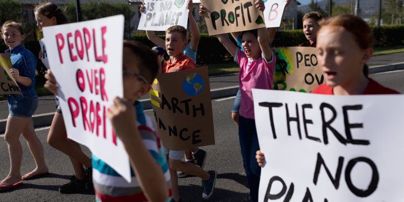 Group of elementary school pupils walking on a protest march